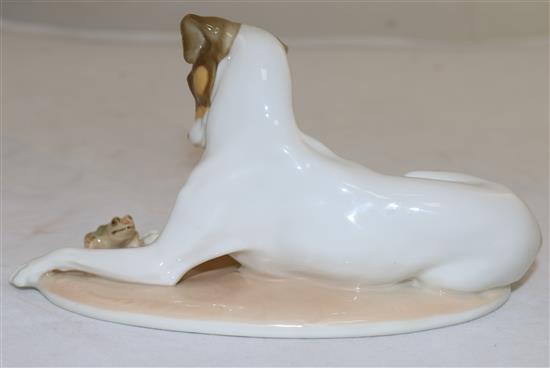 A Nymphenburg polychrome figure of a recumbent hound and frog, modelled by T. Karner, late 20th century, length 17cm (6.7in.)